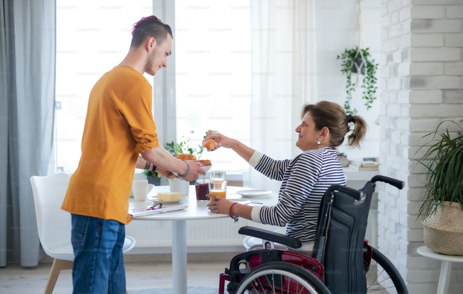 Support worker helping participant with daily routine at home